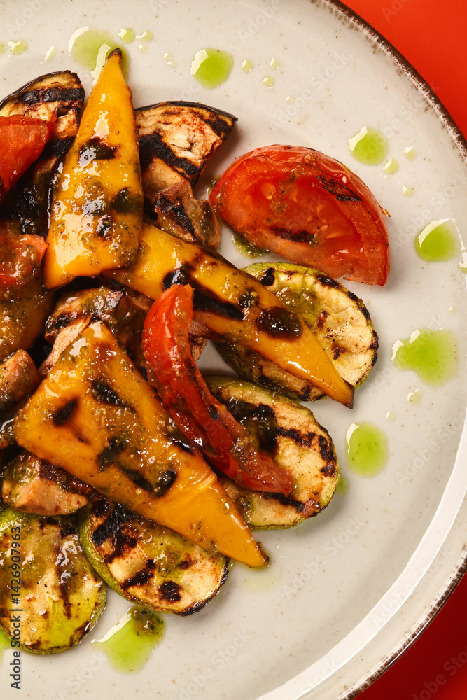 Grilled vegetables with pesto sauce on a plate: delicious and healthy vegetarian meal