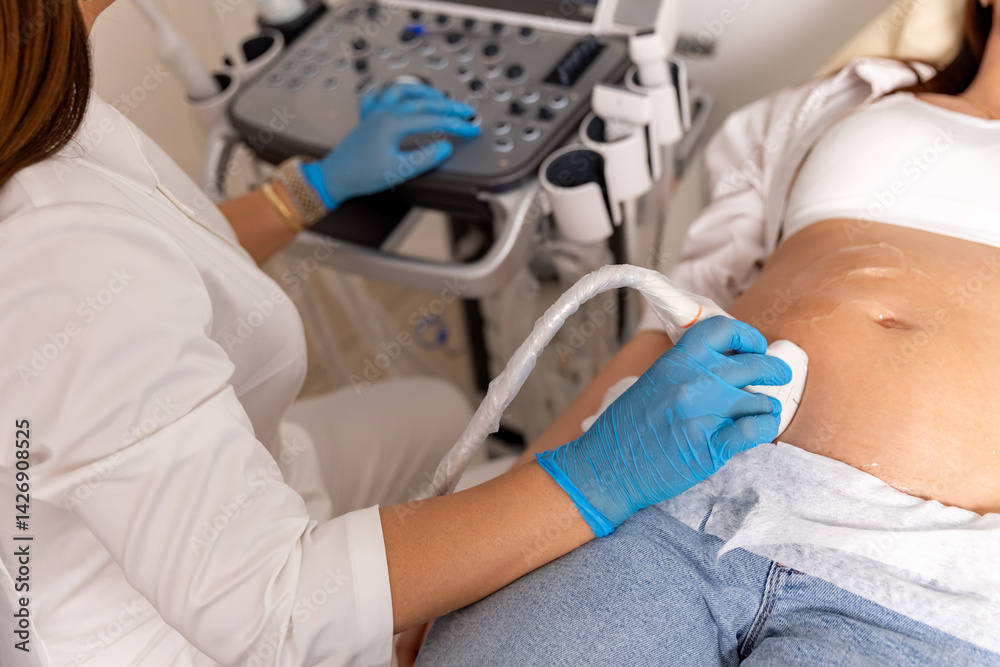Doctor hands with ultrasonic during ultrasound medicine examination of pregnant patient. Maternity, pregnancy, fertility concept. Future mom checking on the embryo. High quality photo. Top view