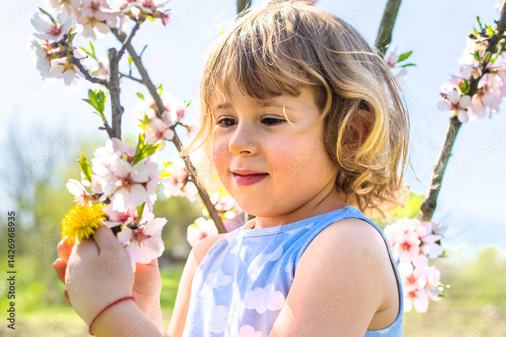 Child in a garden of flowering trees. Selective focus. Child in a garden of flowering trees. Selective focus.