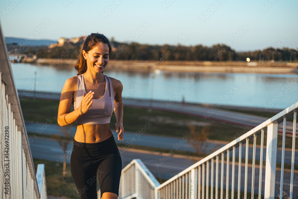 Young Woman Running Up Stairs Outdoors With A River Background