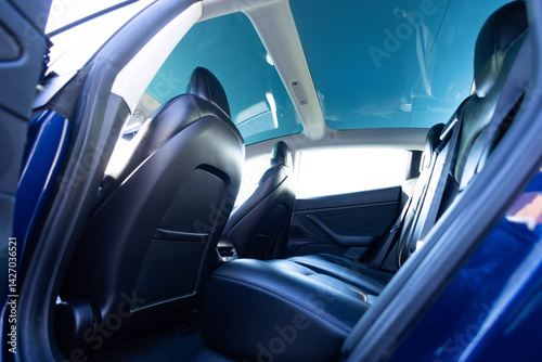 Wallpaper Mural Panoramic glass sun roof in the modern electric car. Clean sunroof and view at the sky from the inside or car interior. The view from the empty car with rear seats Torontodigital.ca
