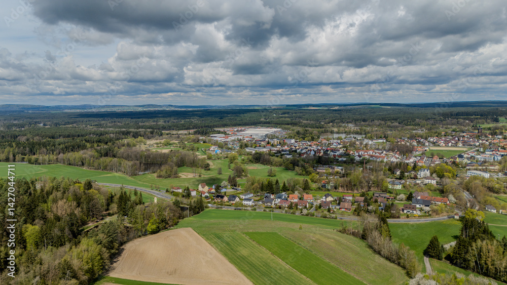 View of a city embedded in green forests and meadows View of a city embedded in green forests and meadows