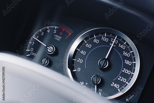 Car speed dashboard closeup. Speedometer and tachometer. Fast driving concept. Auto instrument panel. Modern vehicle detail. Travel and transport. Drive fast. Sport car style. Car interior background.
