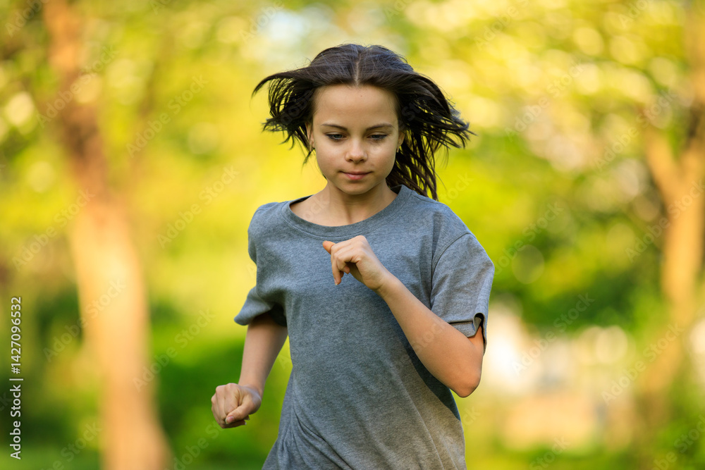 Portrait of preteen girl in park in spring.