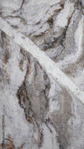 Luxury quartz stone texture pattern with trendy curly veins close up. Marble white slab on black background in Slow motion