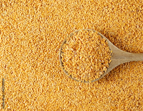 Wallpaper Mural Organic golden flax seeds, linseed grains in wooden spoon background and texture Torontodigital.ca