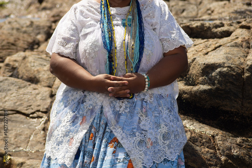 A Candomble practitioner is seen in the water at Rio Vermelho beach paying homage to Iemanja. Salvador, Brazil.