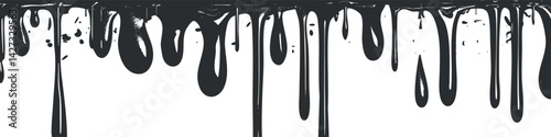 Black paint dripping down a white background creating a textured and artistic effect.
