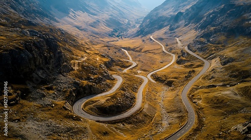 Winding mountain road snakes through a rugged valley.