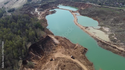 Panoramic view from high altitude of partially flooded sand quarry