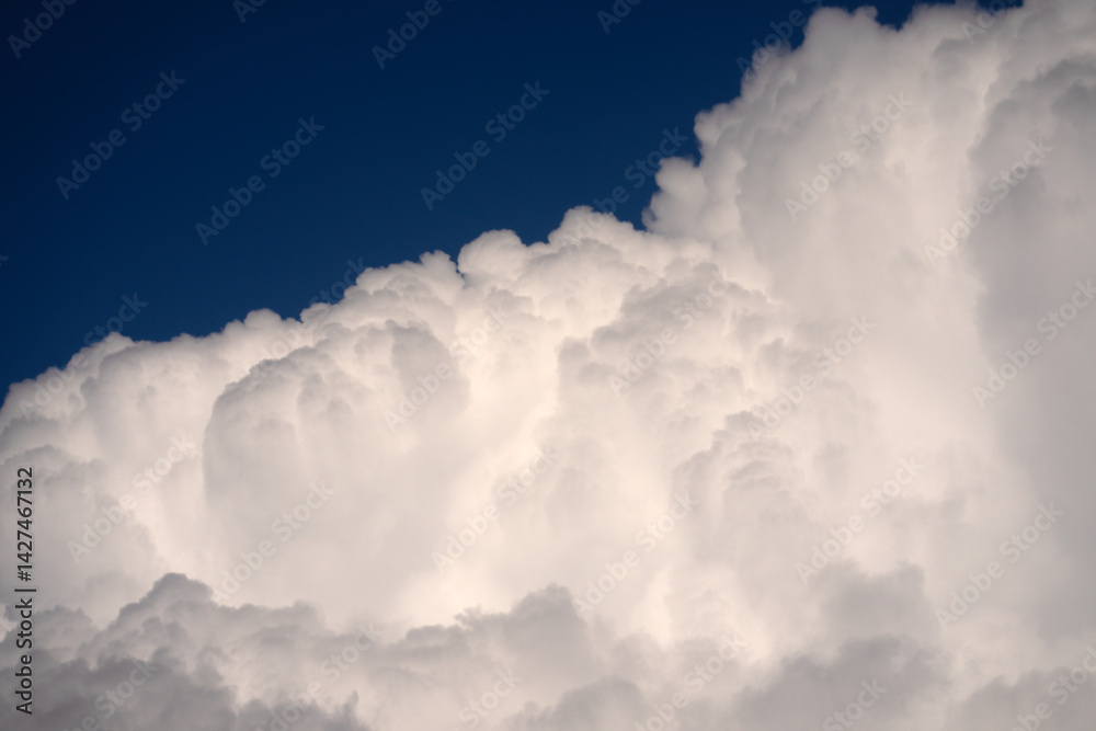 Obraz premium Blue sky with calm clouds background. Bright blue sky background. Cloudscape with white clouds. Calm sky cloudy on a summer day. Sunlight through the clouds wallpaper. Spring sky with soft clouds.