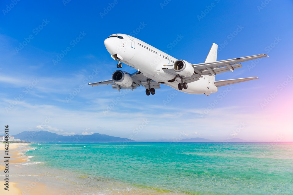 Naklejka premium Airplane jet flies over tropical beach on ocean coast, arrival at resort airport