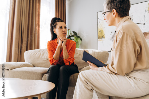 Psychologist listening to Latin patient talking about problems during therapy session