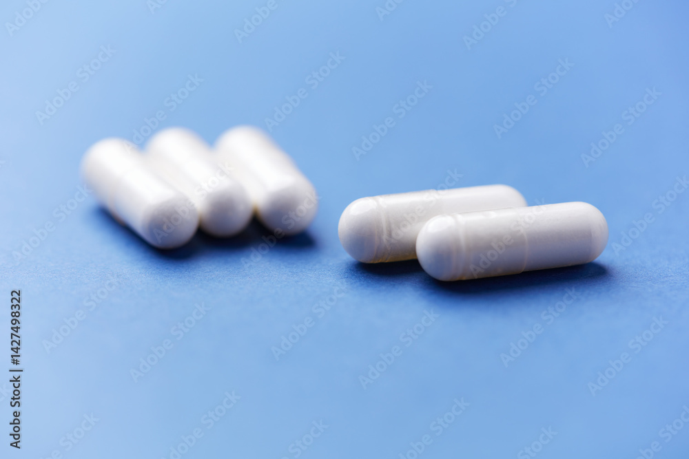 Arginine capsules on bright background. Soft focus. Close up. Copy space. Arginine capsules on bright background. Soft focus. Close up. Copy space.