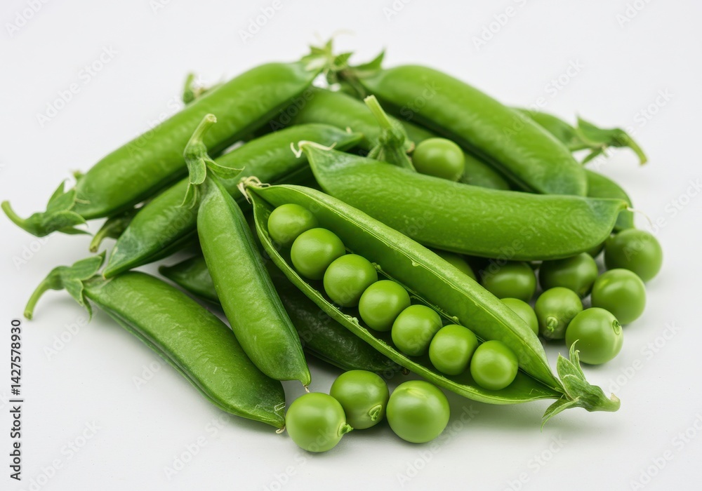 A pile of fresh green peas in pods and loose on a white surface showing the vibrant color and texture A pile of fresh green peas in pods and loose on a white surface showing the vibrant color and texture