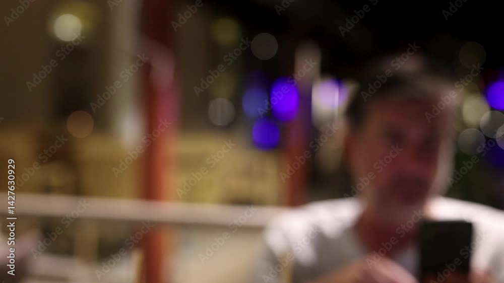 Blurred Man Using Phone in Restaurant Blurred Man Using Phone in Restaurant