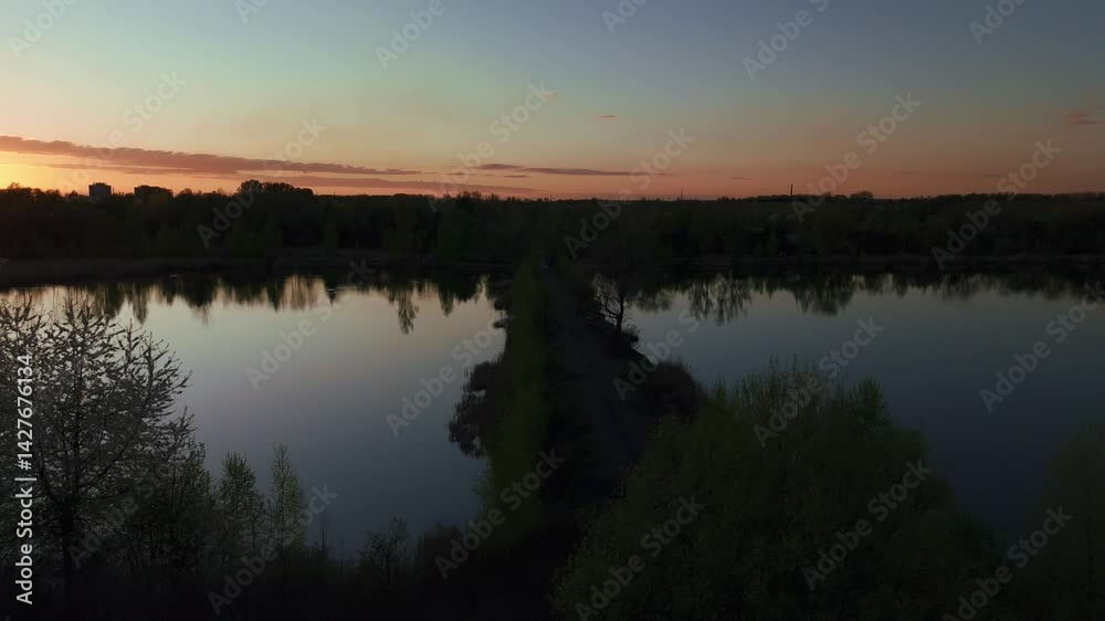 Smooth lateral drone flight over scenic lakes during golden hour. The tranquil water surface and surrounding forest create a cinematic and immersive experience. Captured in 4K at 30fps Smooth lateral drone flight over scenic lakes during golden hour. The tranquil water surface and surrounding forest create a cinematic and immersive experience. Captured in 4K at 30fps