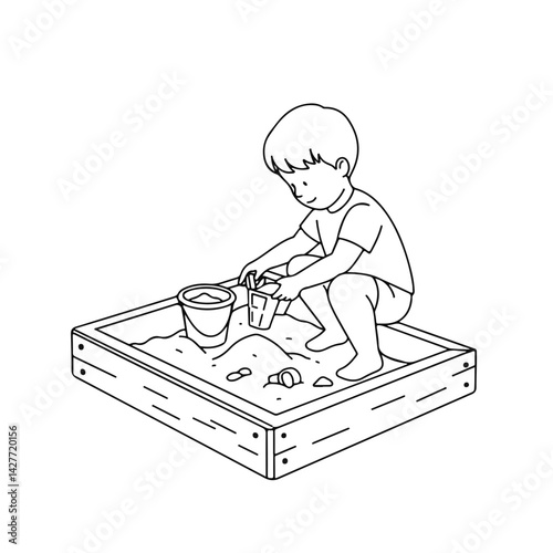 Child playing joyfully in a sandbox drawing  
