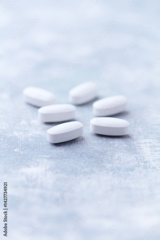 Amino acids tablets on wooden background. Soft focus. Close up