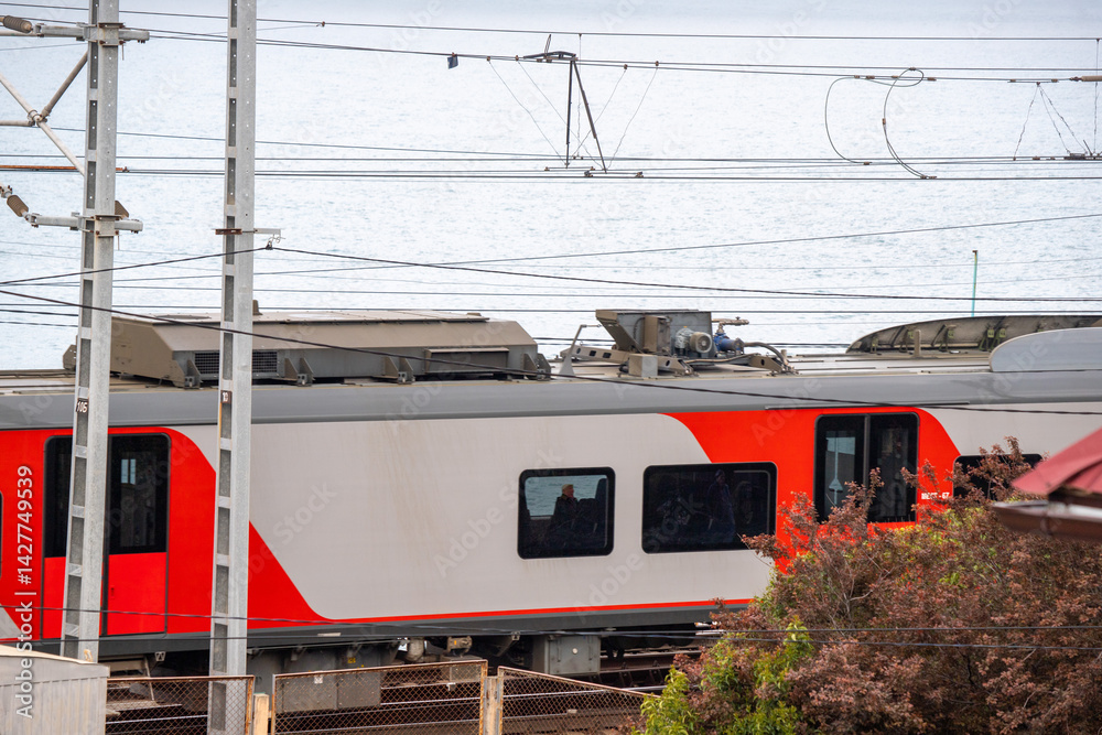 A train is sitting on the tracks next to a body of water A train is sitting on the tracks next to a body of water