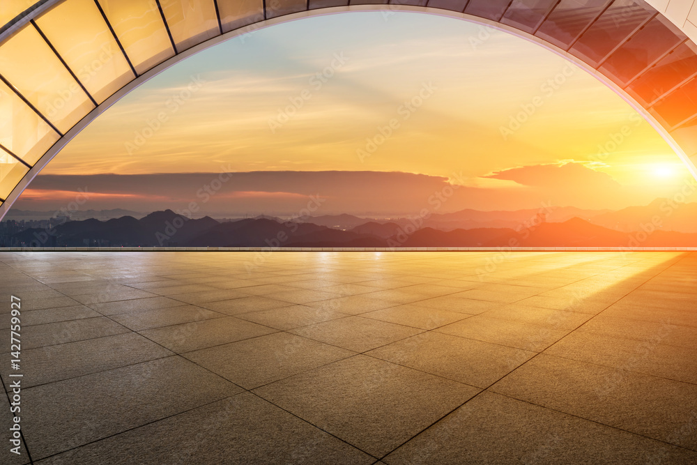 Empty square floor and arched bridge with mountain scenery at sunset