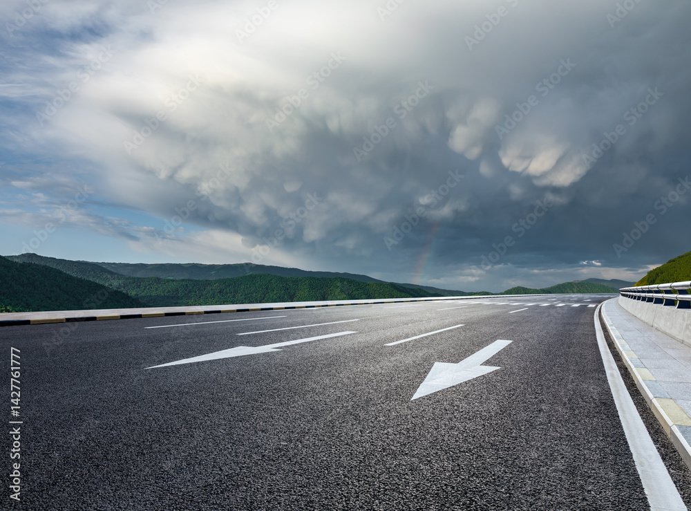 Asphalt road and green mountain with dramatic sky clouds nature landscape in summer