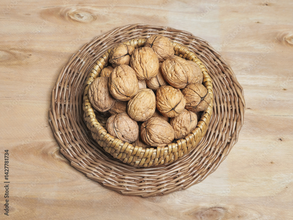 Inshell walnuts in a wicker bowl.