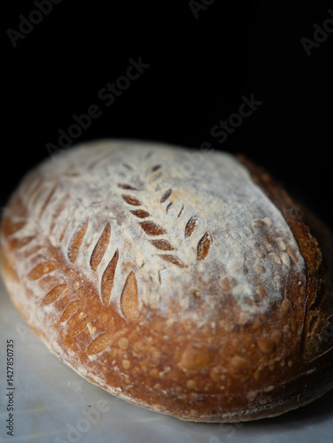 A close-up view of crusty sourdough bread showcasing its golden, textured crust and airy crumb, highlighting artisan craftsmanship and fresh, wholesome, homemade quality.