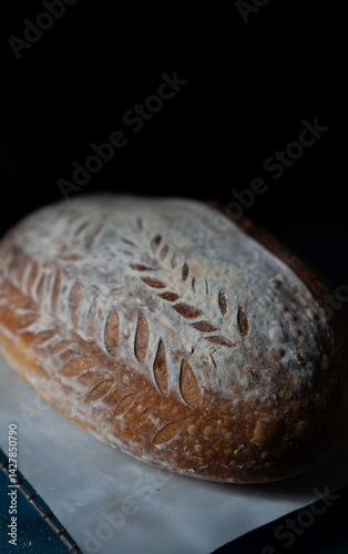 A close-up view of crusty sourdough bread showcasing its golden, textured crust and airy crumb, highlighting artisan craftsmanship and fresh, wholesome, homemade quality.