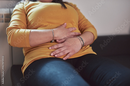 Obraz na płótnie Woman with strong stomach ache, menstrual and digestive issues at home. w salonie