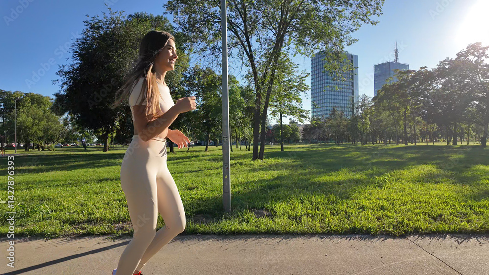 Young woman running and jogging in urban park.