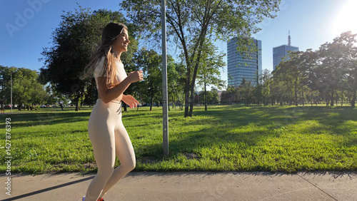 Obraz na płótnie Young woman running and jogging in urban park. w salonie
