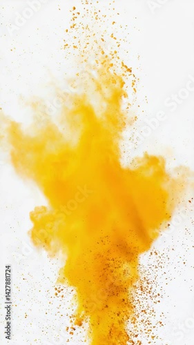 Abstract golden yellow dust explosion on white background creating a cloud of pigment