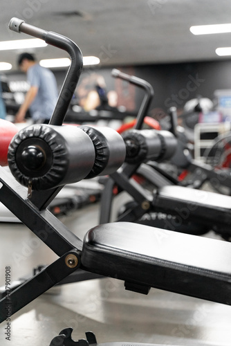 Wallpaper Mural sstkWellness captures the essence of modern fitness with this striking image of a mechanical strength training machine loaded with weight plates, highlighting the synergy between structured physical Torontodigital.ca