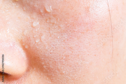 Close-up of a woman's face sweating in the hot summer