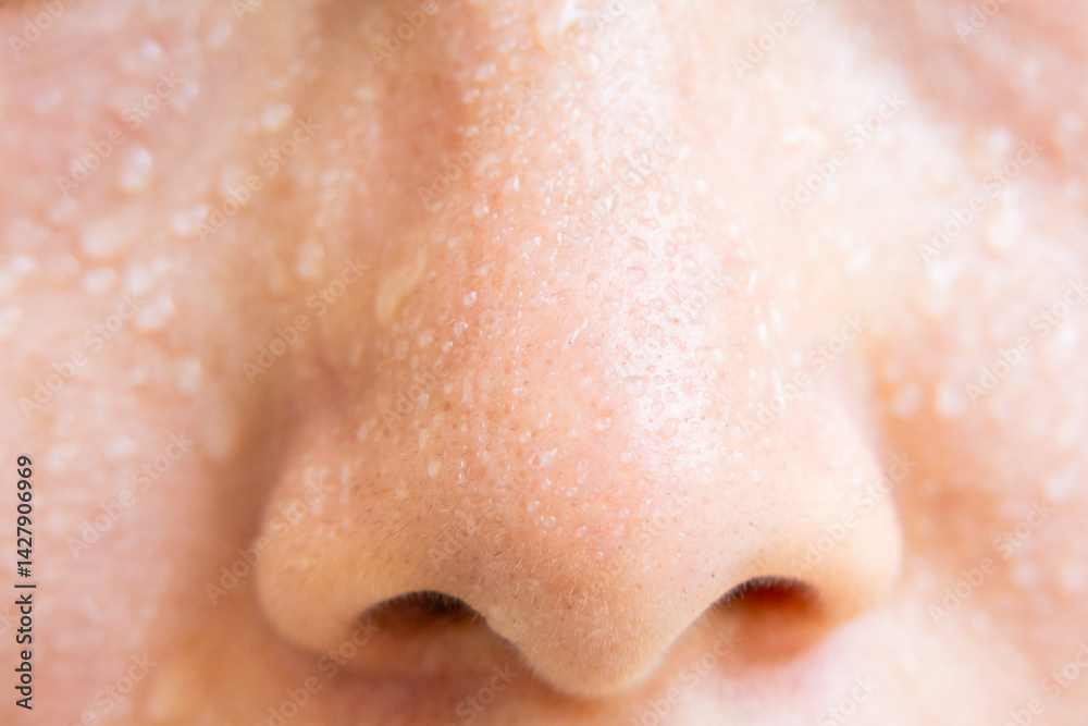 Fototapeta premium Close-up of a woman's face sweating in the hot summer