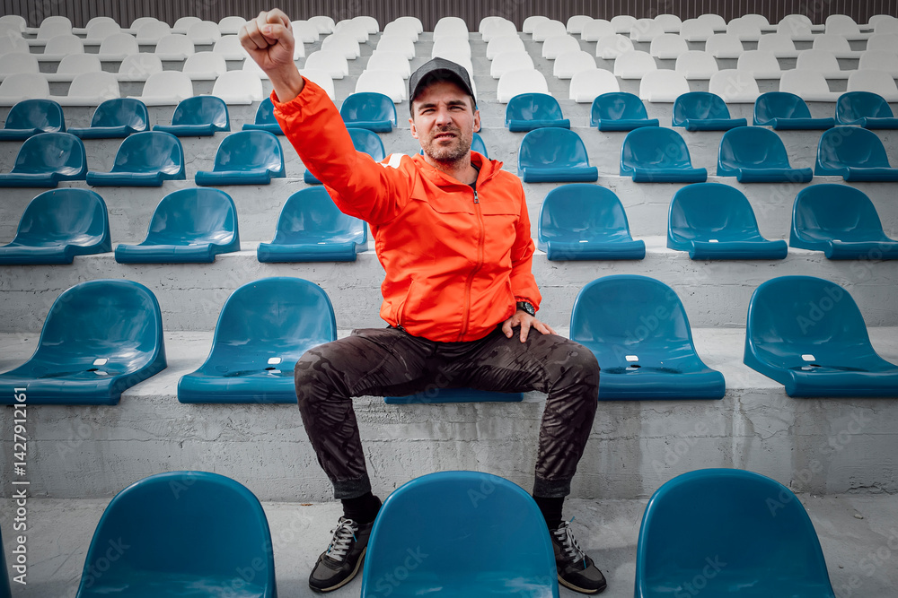 Football fans clapping on the podium of the stadium. one single fan at stadium is rooting for his favorite football team during quarantine or lockdown from the covid 19 coronavirus