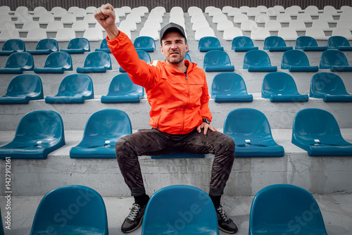 Obraz na płótnie Football fans clapping on the podium of the stadium. one single fan at stadium is rooting for his favorite football team during quarantine or lockdown from the covid 19 coronavirus w salonie