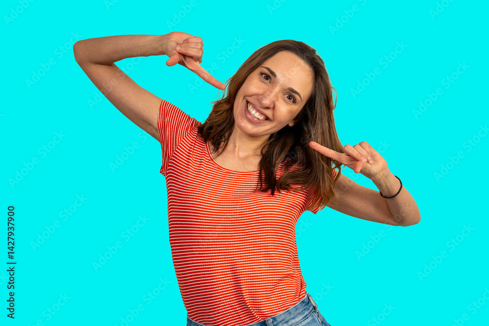 Fototapeta premium Cheerful young woman pointing at herself smiling on turquoise background