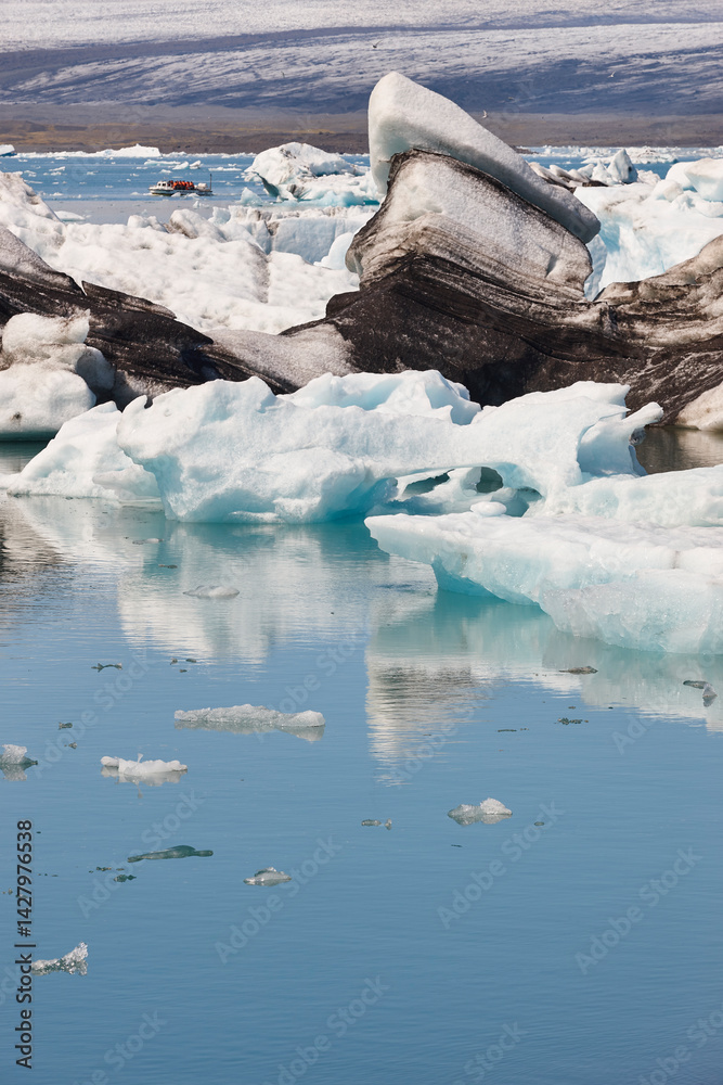 Icebergs turquoise lake and snowy mountains. Jokulsarlon, Southeast area. Iceland.