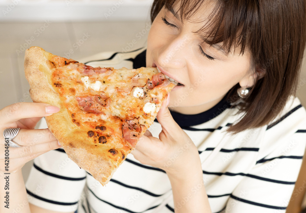 girl eating tasty delicious piece pizza with bacon, in cafe. woman holding with hand one slice.female biting delicious junk food.view from front and over the shoulder.advertising banner restaurants girl eating tasty delicious piece pizza with bacon, in cafe. woman holding with hand one slice.female biting delicious junk food.view from front and over the shoulder.advertising banner restaurants