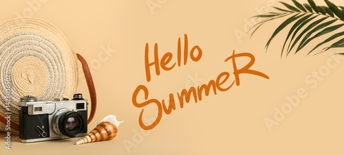 Vintage photo camera, beach bag, sea shell and palm leaf on beige background. Hello, summer