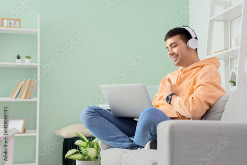 Young man in headphones wit...