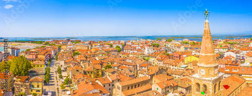 A panoramic aerial view of the old town of Grado, Italy, showcasing its charming historical architecture, red-tiled roofs, and coastal setting along the Adriatic in the Friuli-Venezia Giulia region
