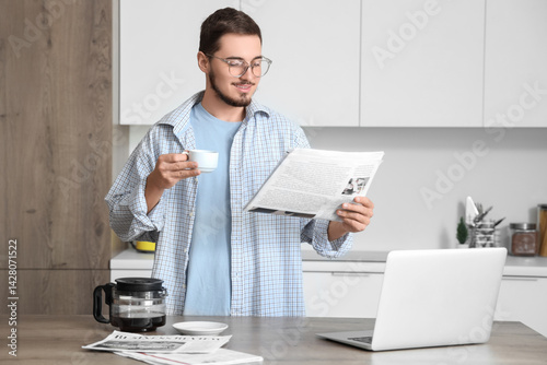 Young man with newspaper an...