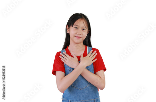 Obraz na płótnie Portrait of smiling Asian girl child hugging herself holds hands on chest gesture on white background. Kid place arms on heart gesture of love. w salonie