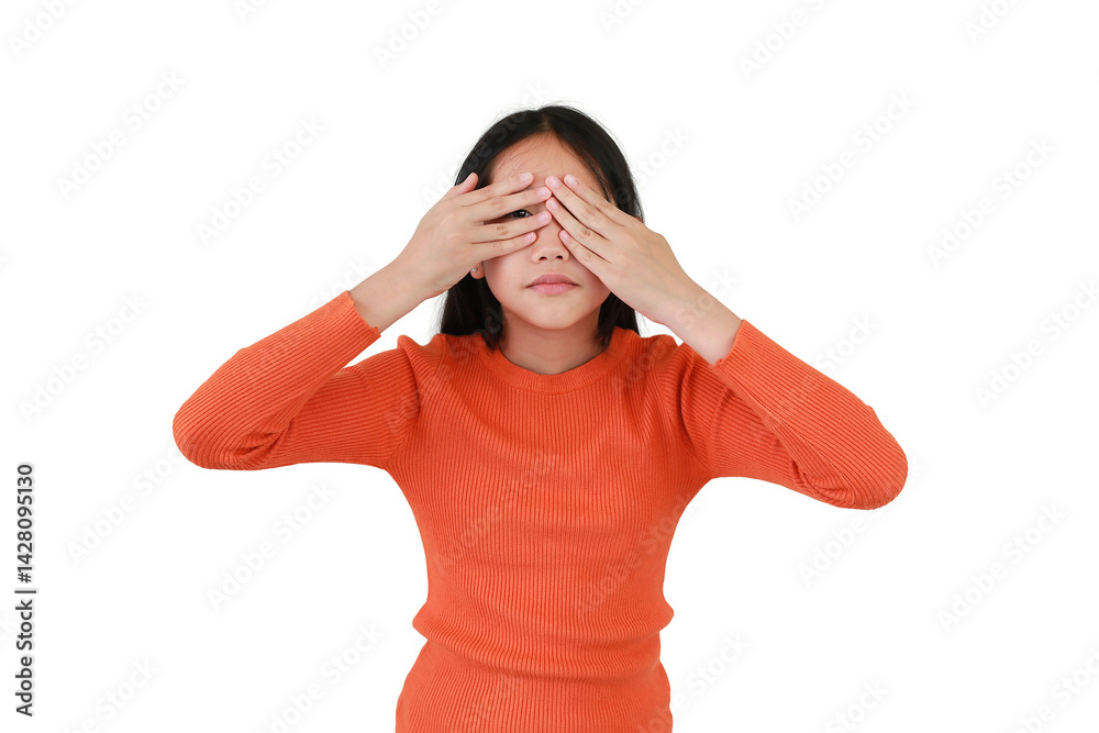 Asian girl child spying through hole between fingers. Kid peeks through his fingers isolated on white background. Children playing hide and seek concept.