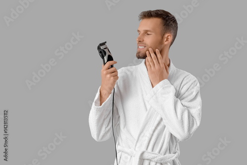 Bearded young man with elec...