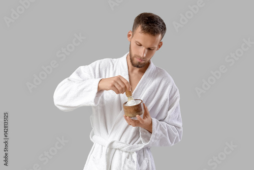 Bearded young man applying ...