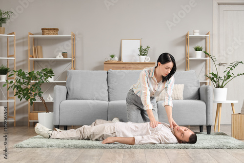 Young woman checking pulse ...
